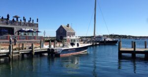 edgartown harbor with seafood shanty in background and boat in water